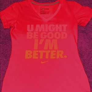 Nike Low V Pink shirt with orange colored words